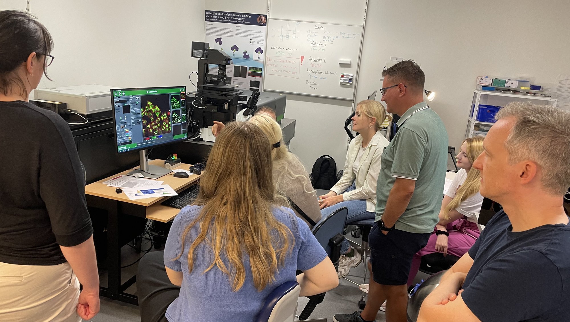 Members of the Single Molecule Biophysics and Chemistry group testing out the Luminosa microscope. 